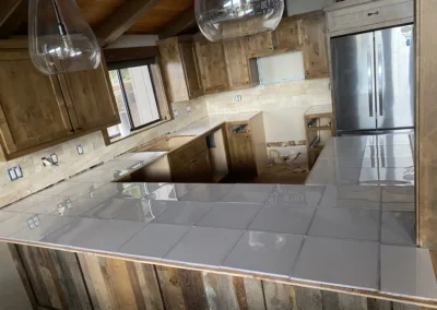 Modern kitchen with wooden cabinets and stainless steel appliances under construction.